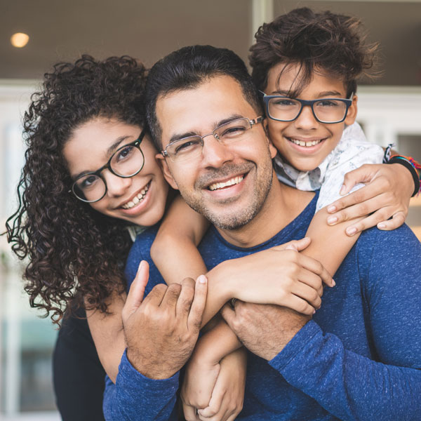 smiling family of three