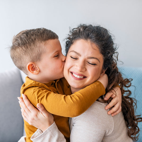 son kissing mother on cheek